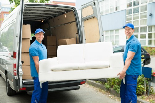 Removal team preparing household items for transport