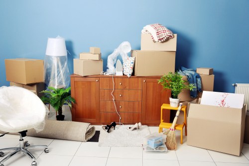 Movers placing desks and storage units in a new Finchley office layout