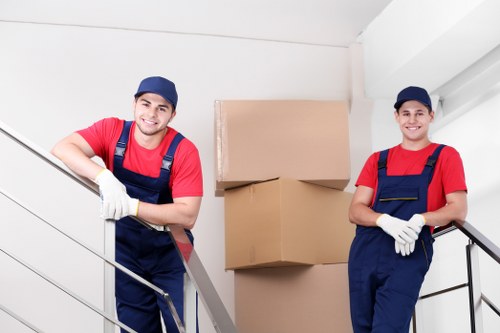Staff using protective gloves and safe lifting techniques during removals