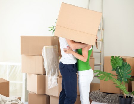 Professional movers handling desks and office equipment in Finchley