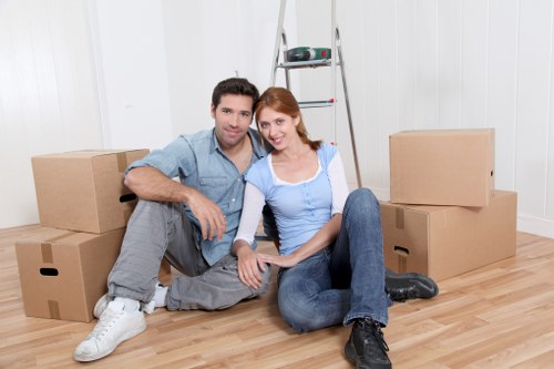 Professional van driver assisting with moving boxes in Finchley