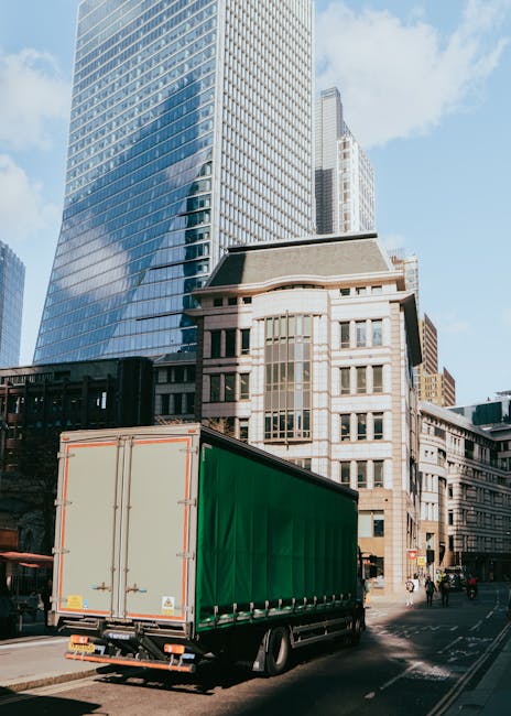 Inside a residential property, a home relocation process is underway with several cardboard boxes of various sizes stacked on the floor, some sealed with packing tape and others open, revealing tissue